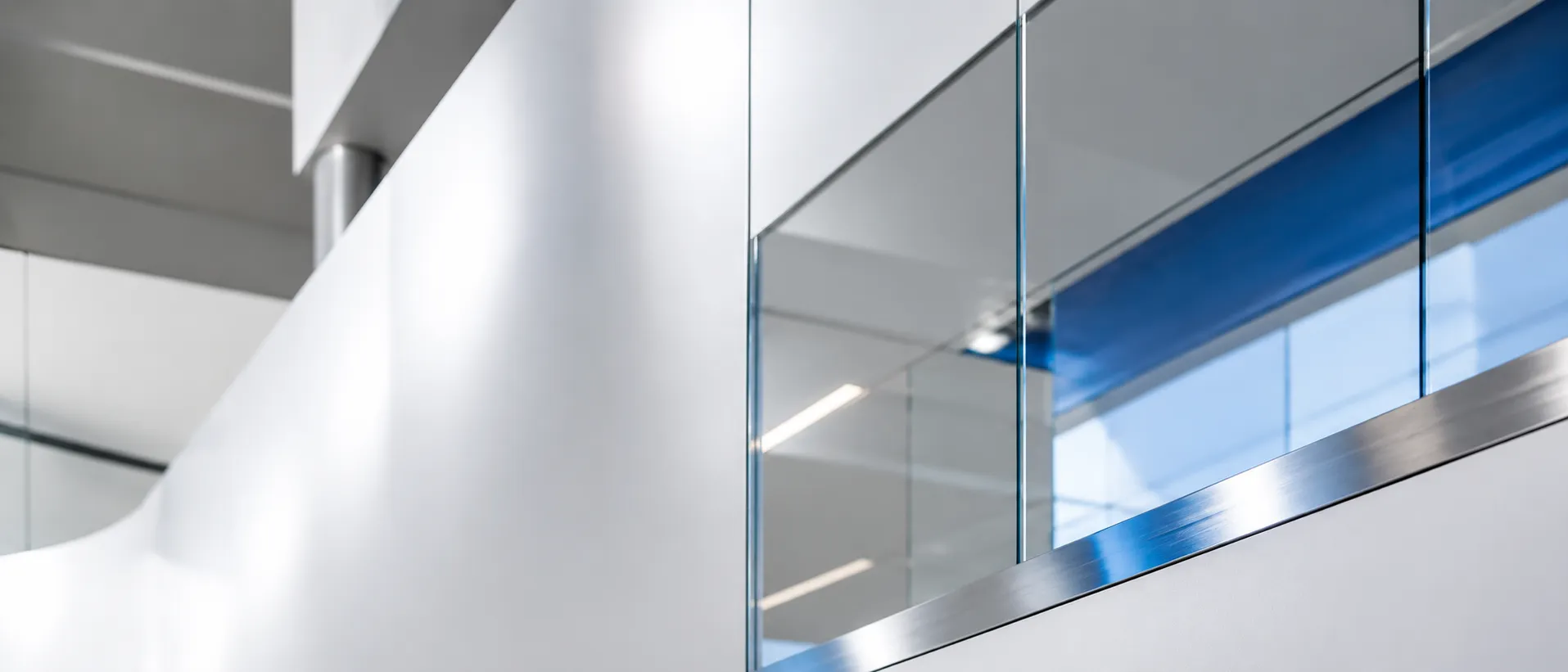 Clean modern architecture in glass and steel with a deep blue accent